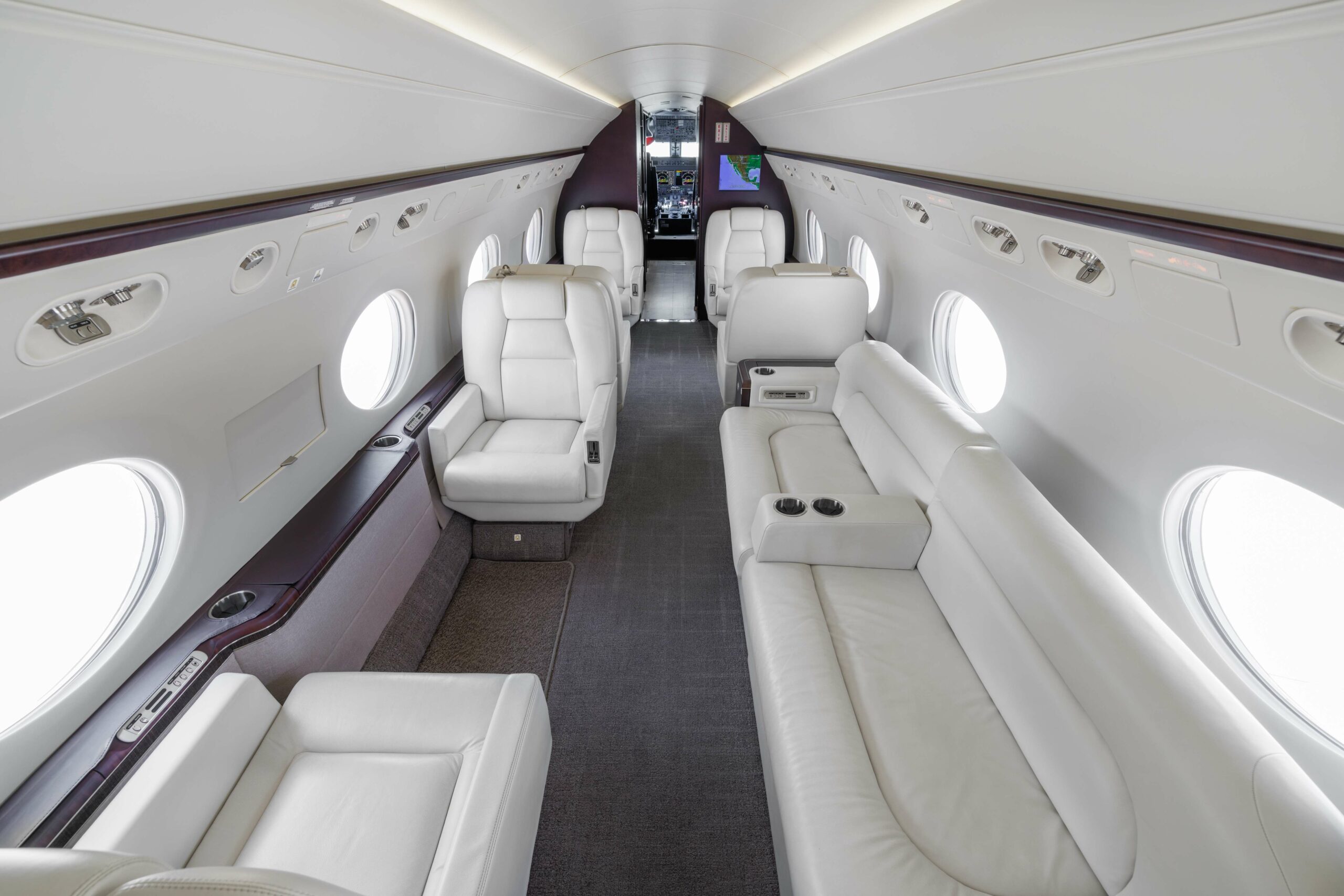 Mid-cabin view of Gulfstream G550 SN5127 showing luxurious white leather seating and cabin layout
